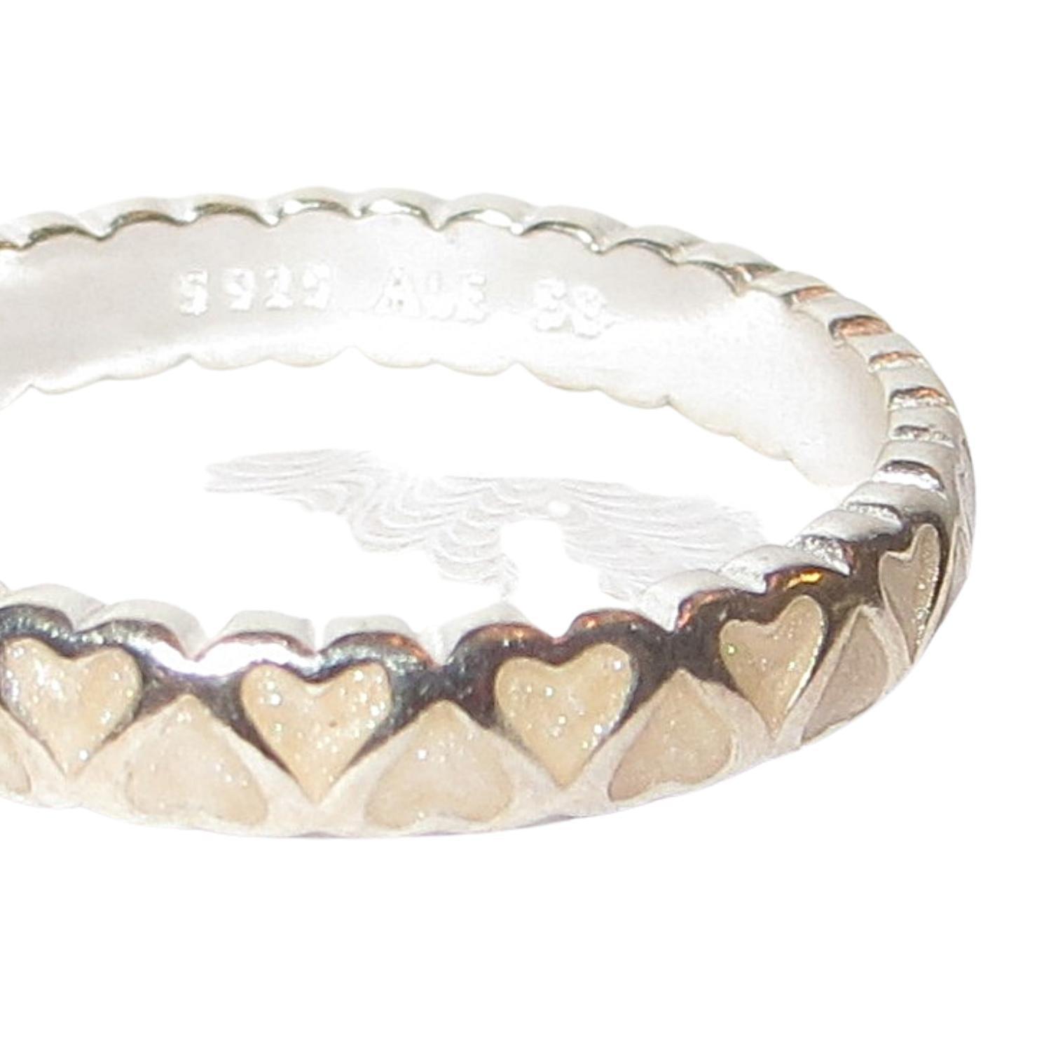Pandora 190975EN23 ABUNDANCE OF LOVE Enamel and Sterling Silver Stacking Ring.  A medium width stacking band with creamy white enamel hearts set in sterling.